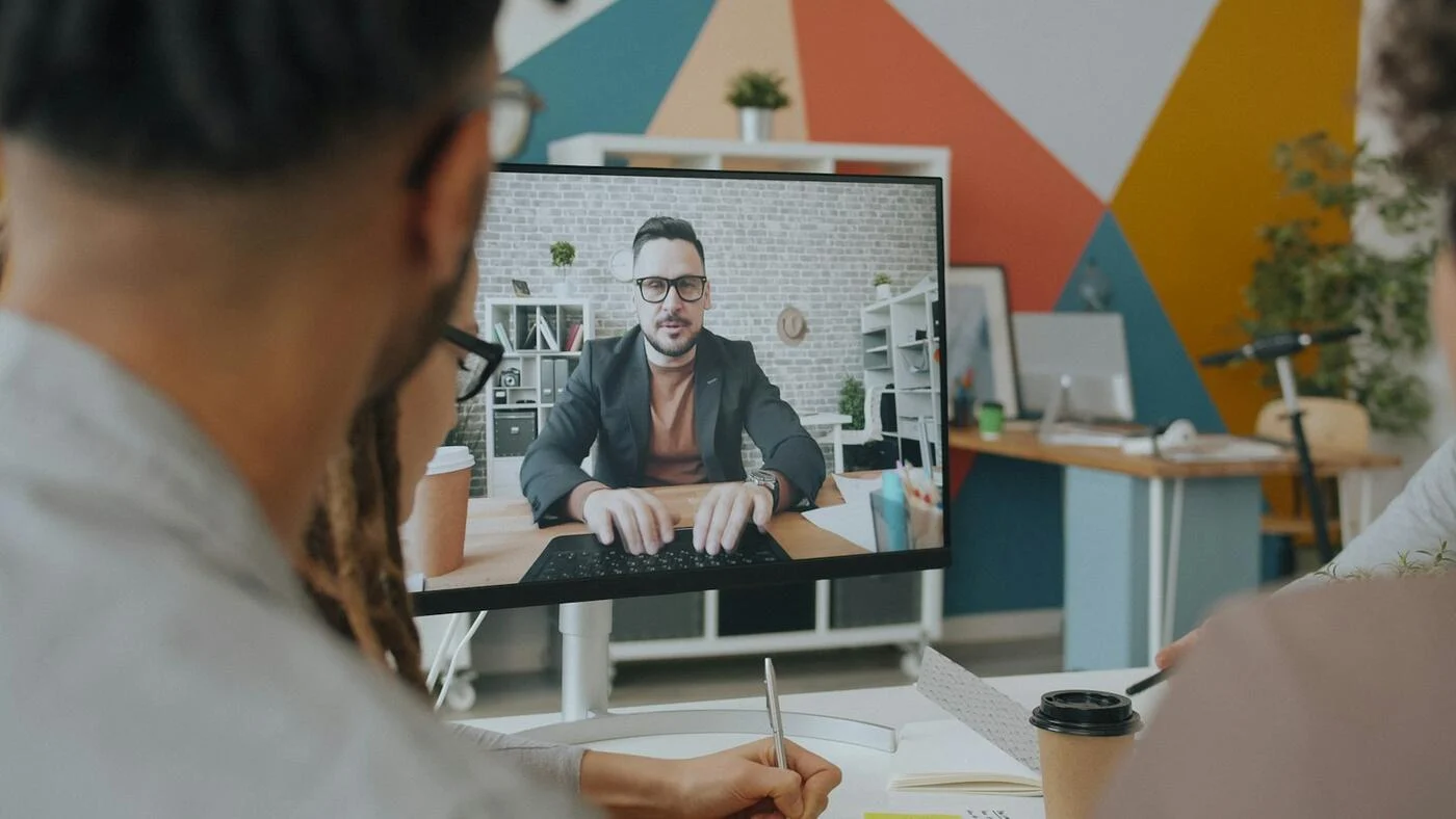 A team in a meeting room on a video conference call