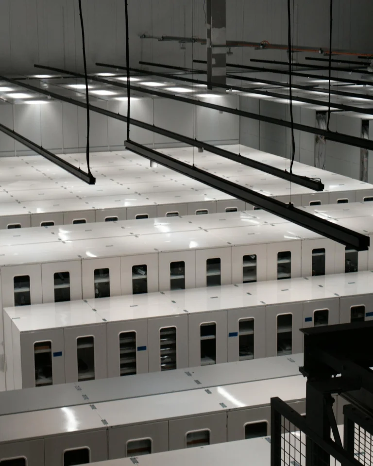 Rows of white server cabinets in a clean data centre